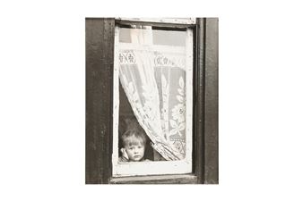 CHILD AT A WINDOW IN SALFORD - Shirley Baker